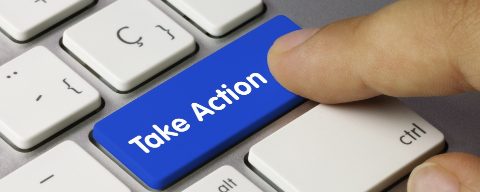 Photo of a computer keyboard with a person's finger hovering over a blue button that says "take action"