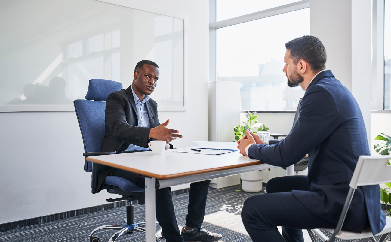 Two businessmen discussing in corporate office during during business meeting