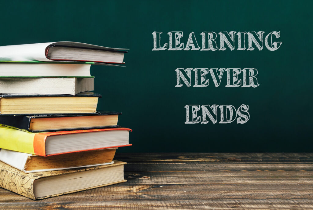 A stack of books with the words learning never ends written on top. The image conveys the idea that learning is a continuous process and that there is always more to learn.