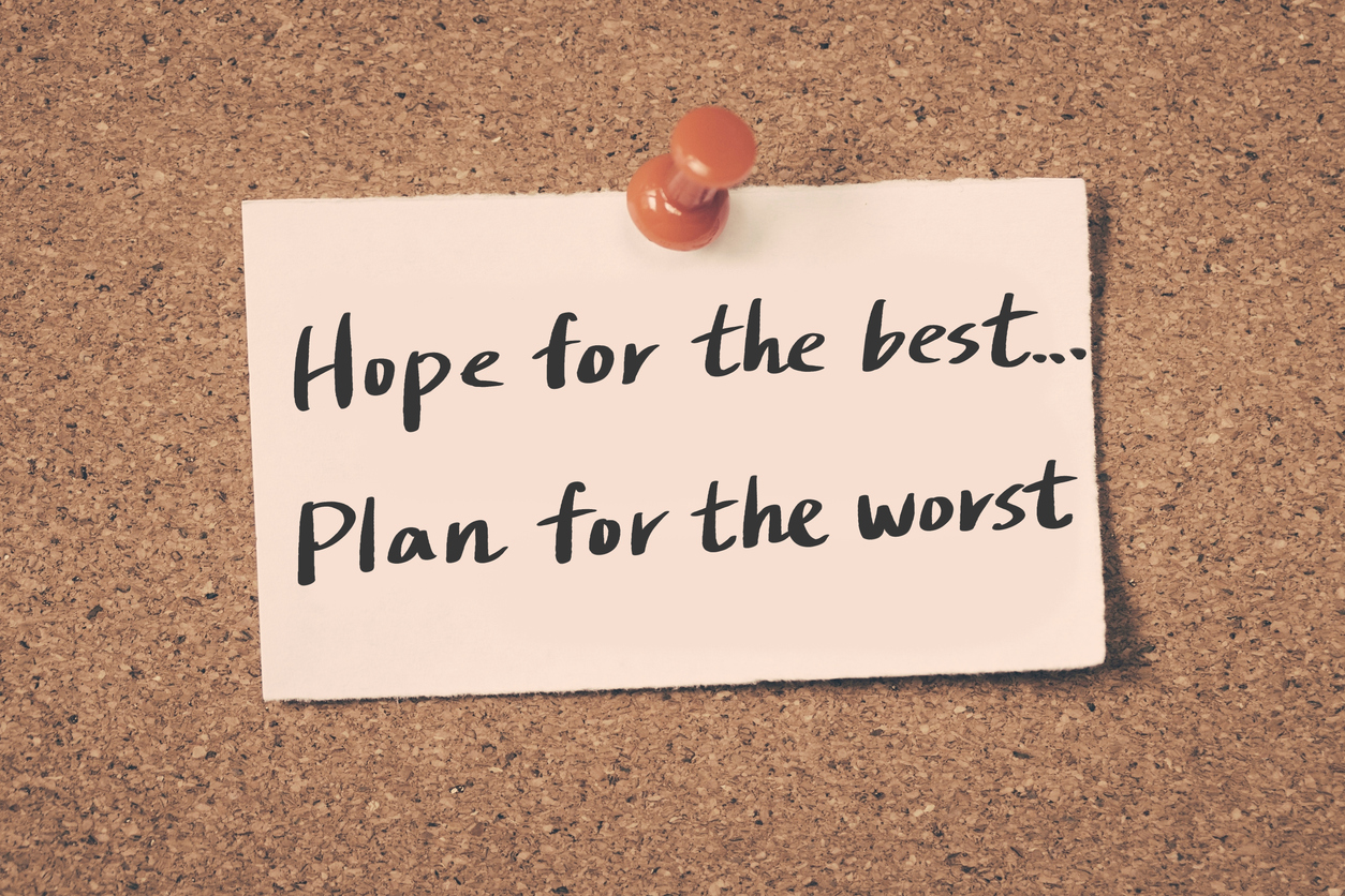 A note that says "Hope for the best... Plan for the worst" pinned to a corkboard with a red push pin