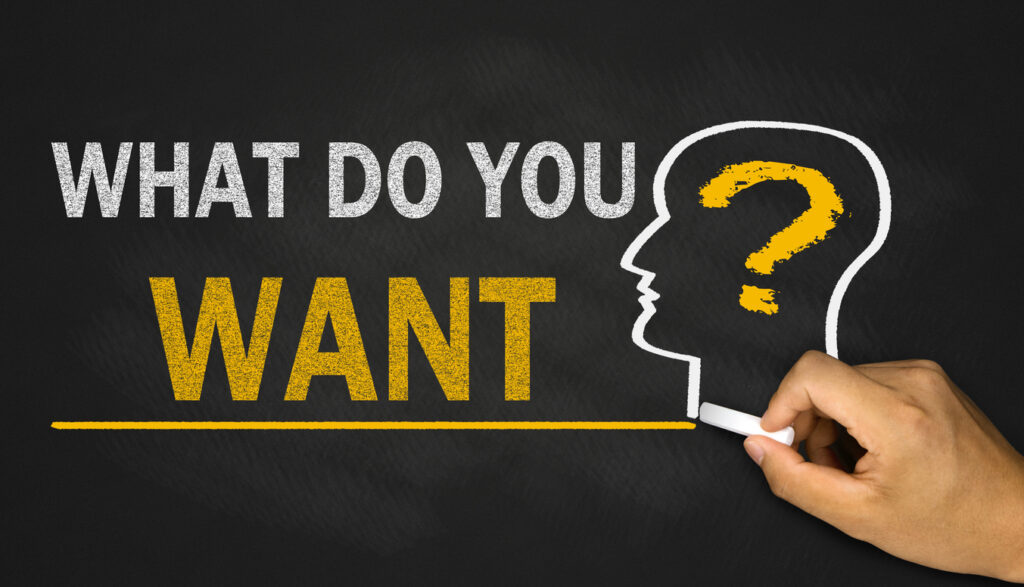 A chalkboard graphic asks, “WHAT DO YOU WANT?” beside a profile of a head with a question mark, suggesting self-reflection or goal-setting.