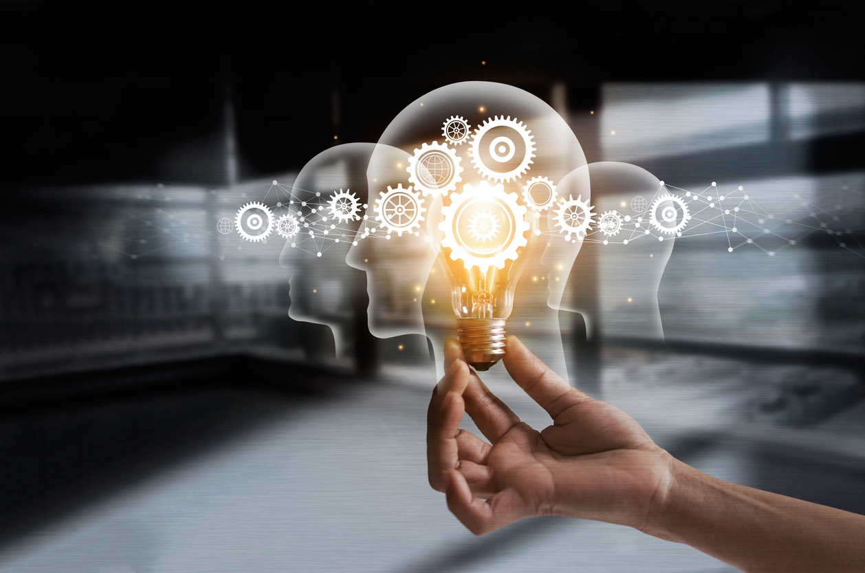 Hand holding light bulb and cog inside. Idea and imagination. Creative and inspiration. Innovation gears icon with network connection on human heads on metal texture background. Innovative technology in science and industrial concept
